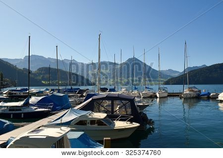 Vitznau, Switzerland 29.09.2019: Sailing Boats Resting In The Port Of Vitznau On Lake Lucerne With V