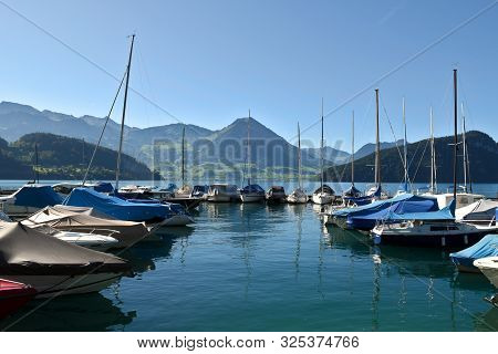 Vitznau, Switzerland 29.09.2019: Sailing Boats Resting In The Port Of Vitznau On Lake Lucerne With V