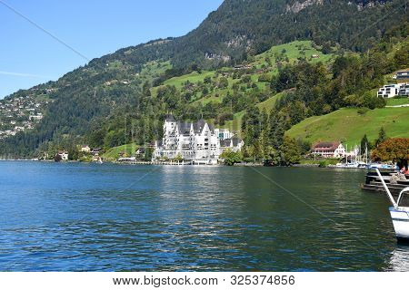 Vitznau, Switzerland 29.09.2019: Beautiful Green Hillside Meadow With The View Of Park Hotel Vitznau