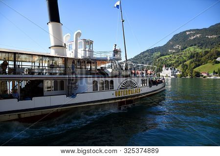 Vitznau, Switzerland 29.09.2019: A Steamboat With Tourist Is Leaving The Port
