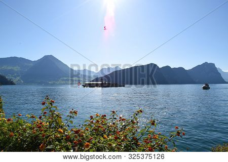 Vitznau, Switzerland 29.09.2019: A Steamboat With Swiss Flag On The Back Is Crossing Lake Lucerne