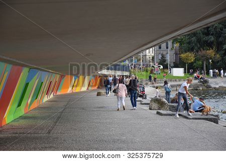 Zug, Switzerland 29.09.2019: A Colorful Underpass Where People Walking, Relaxing On The Lake Zug Lak