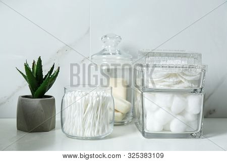 Cotton Swabs, Pads And Balls On White Countertop In Bathroom