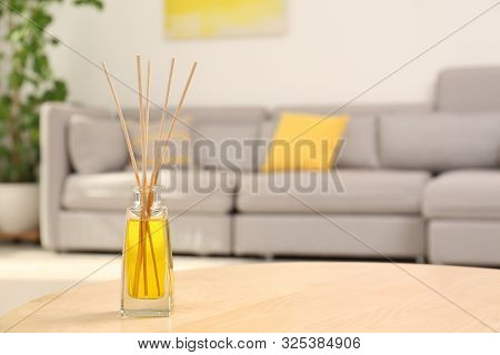 Reed Air Freshener With Essential Oil On Table In Room. Space For Text