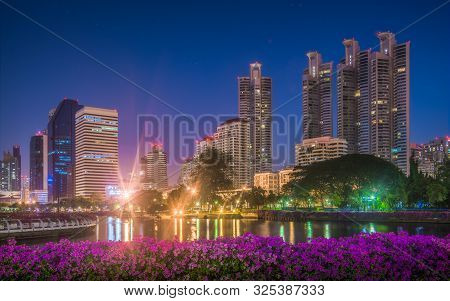 Skyscrapers Near Benjakiti Public Park At Night In Bangkok, Thailand