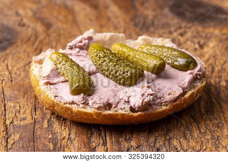 Liver Sausage Spread On A Bun On Wood