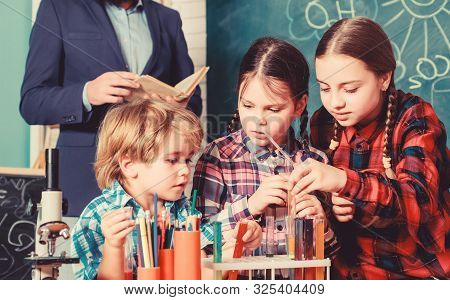 Inspired To Work Hard. Happy Children Teacher. Doing Experiments With Liquids In Chemistry Lab. Chem