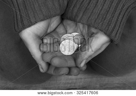 Beggar Holds Palms With Coins And Asks For Help Close-up.