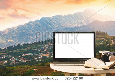 Mockup Image Of Laptop With Empty Screen With Camera,notebook,coffee Cup On Table With At Mountanis 