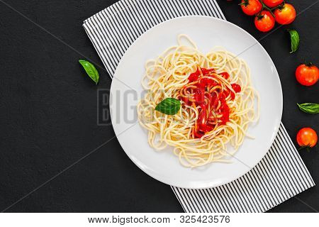 ?lassic Italian Spaghetti Pasta With Tomato Sauce And Basil On Plate On Dark Table. View From Above,