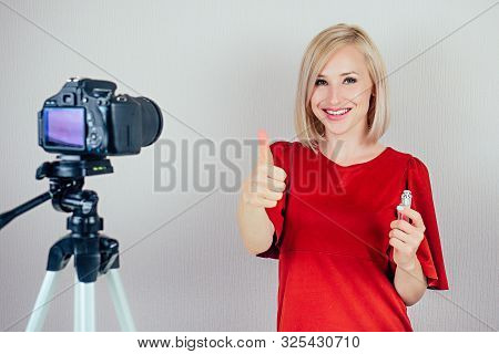 Attractive Blond Videoblogger Beauty Blogger Woman In A Red Dress Records Video Blog About The Care 