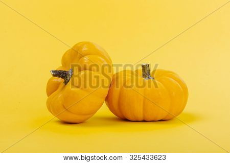Halloweeen Theme With A Pumpkins On A Yellow Background
