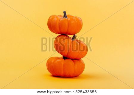 Halloweeen Theme With A Pumpkins On A Yellow Background