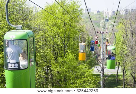 Kharkov, Ukraine - April 30, 2018: Colourful Cabins On Rope In The City Park. Panorama Of Cablecars 