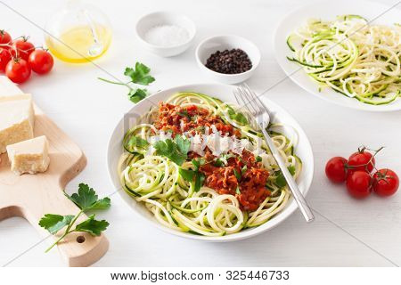 keto paleo zoodles bolognese: zucchini noodles with meat sauce and parmesan