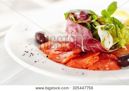 Gourmet, restaurant, delicious dinner food - close up of Fish Dish with Lemon and Fresh Basil Leaves
