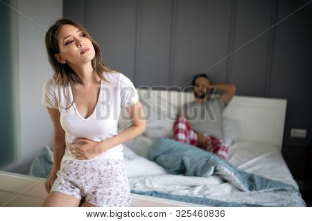 Sad, Upset, Unhappy Woman Holding Hands On Stomach Suffering From Stomach Pain
