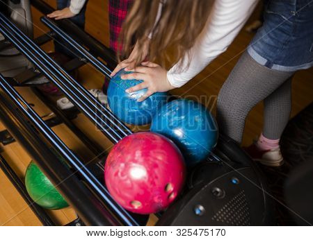 Close-up Hand Holding Bowling Ball Against Bowling Alley - Image. Cheerful Woman Isready To Play - I