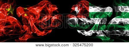 China Vs Abkhazia, Abkhazian Smoke Flags Placed Side By Side. Thick Colored Silky Smoke Flags Of Chi