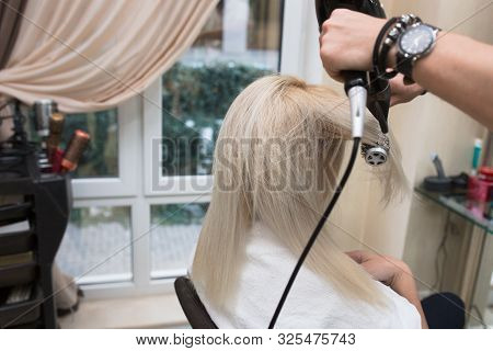 Young Beauty Blonde Attractive Woman At Hairdresser. Close-up Of Gray Silver Platinum Comb Hair Drye