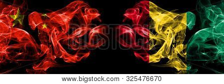 China Vs Guinea, Guinean Smoke Flags Placed Side By Side. Thick Colored Silky Smoke Flags Of Chinese