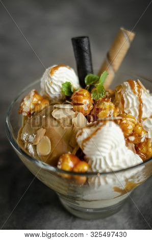 Caramel And Almond Ice Cream With Caramelized Popcorn Sundae Dessert In Glass Bowl