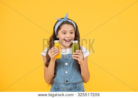 Because Juice Tastes Good. Happy Small Child Hold Bottles Of Juice. Little Girl Enjoy Drinking Fruit