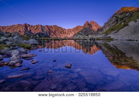 Mountain Landscape And Glacial Taul Portii Lake In Retezat National Park, Carpathian Mountains, Roma