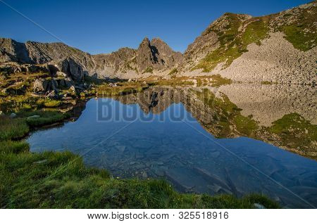 Mountain Landscape And Glacial Taul Portii Lake In Retezat National Park, Carpathian Mountains, Roma