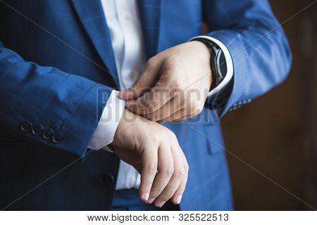 Elegant Young Man Straightens Shirt Sleeve. Style And Fashion.