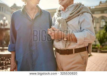 True Love Never Dies. Cropped Photo Of Senior Couple Holding Hands While Standing Together Outdoors.