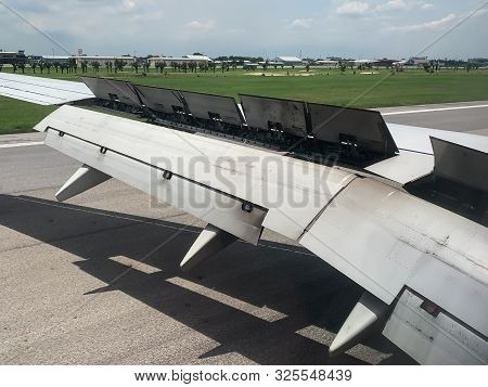 An Airplane Window View Of Wing And Flaps After Landing.