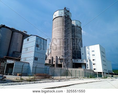 Old Cement Factory. Soviet Industrial Building, Blue Sky.