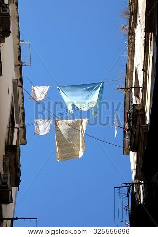 Washing Lines Betwwen Two European Palaces And Blue Sky On Background