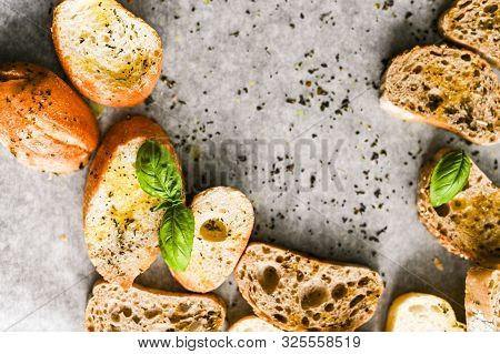 Oven Baked Bruschetta With Basil And Olive Oil In The Oven. Traditional Italian Appetizer. Top View