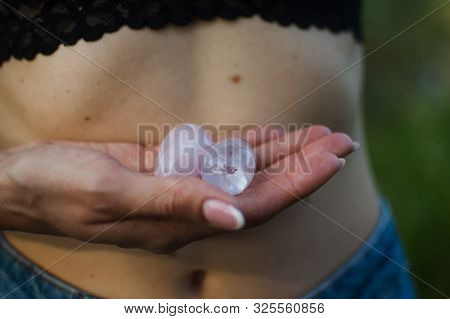 Female Hands Holding Two Yoni Eggs For Vumfit, Imbuilding Or Meditation Are Made From Pink Quartz An