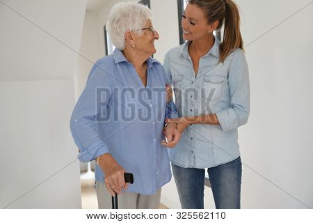 Homehelp girl assisting elderly woman 