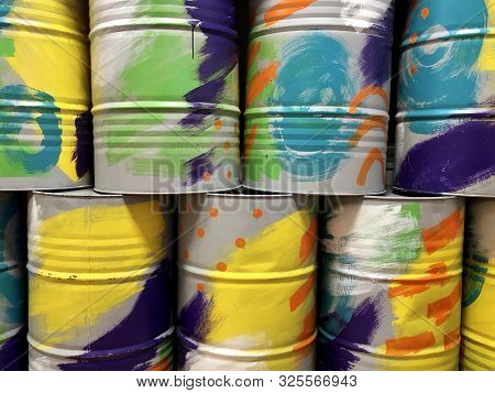 Metal Barrels Are Multi-colored. Background Texture: Barrels Are Painted In Different Colors. Round 