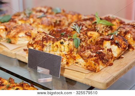 Foccaccia bread with cheese, tomatoes and basil on hotel restaurant table