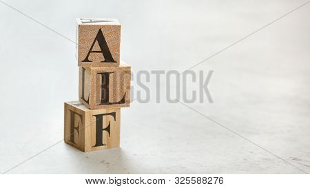 Pile With Three Wooden Cubes - Letters Alf For Always Listen First On Them, Space For More Text / Im