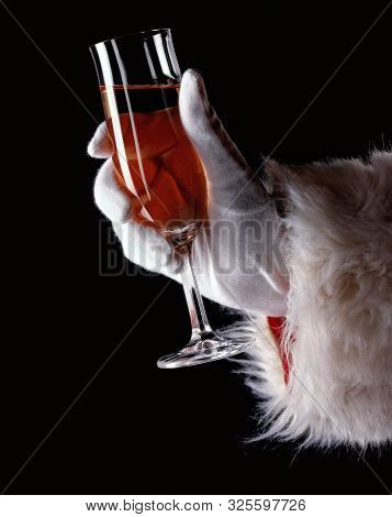 A Hand Holding A Glass Of Wine To Celebrate