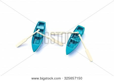 Pair Of Blue Miniature Boats With Oars Isolated With Shadow On White Background. Two Blue Toy Ships.