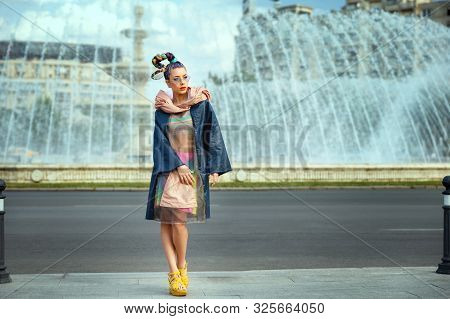 Avant Garde Style With Funky Street Fashion Model Woman With Crazy Hair Posing On City Street
