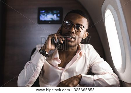 Young Attractive And Successful African American Businessman With Glassies Talking On The Phone And 