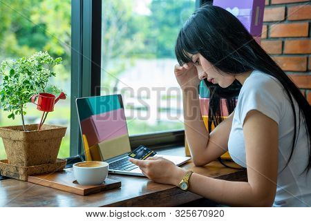 Close Up Image Of An Asian Woman Are Stressed With Credit Card,asian Woman Trying To Find Money To P
