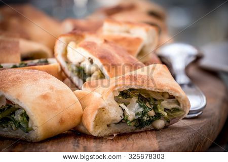 Little Stuffed Pizza With Escarole, Olives And Passed On The Wooden Board, Typical Neapolitan Food O