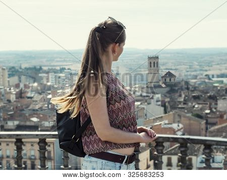 Adult Tourist Girl With Long Blonde Hair Looks At Tarrega City (catalonia, Spain) From The Observati