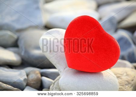 Red Heart On A White Stone. Stones Around