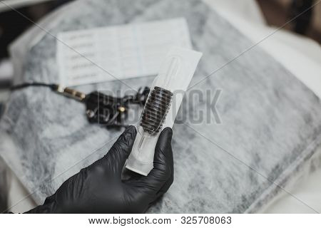Machine For Permanent Makeup In The Hand Of The Master In A Black Glove And A Disposable Needle