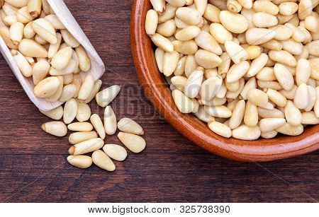 Peeled Pine Nuts. Aerial View (from Above, Top View). Foreground (close-up). Wood Background Rustic,